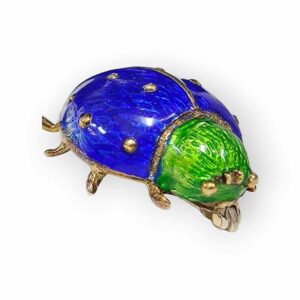 a blue and green turtle brooch with gold accents