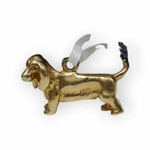 a golden dog ornament with a white ribbon