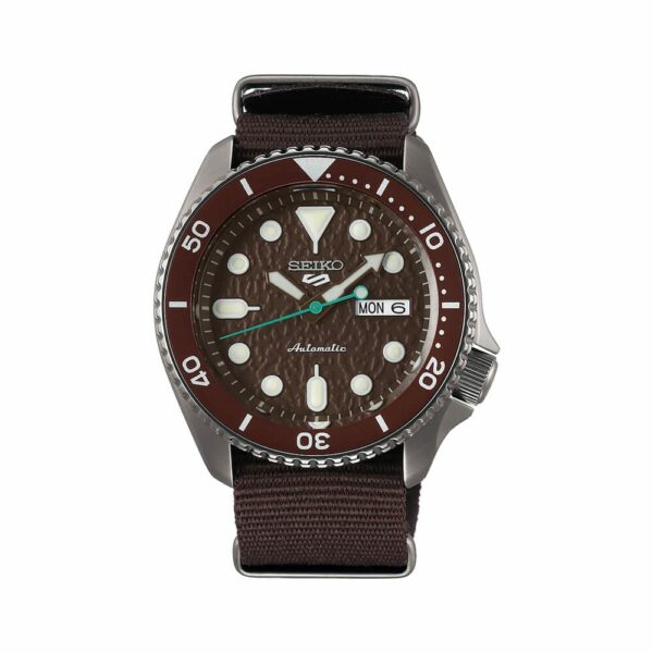 a watch with brown dials and green hands