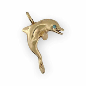a gold dolphin pendant with a blue stone