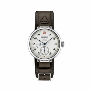 a white watch with brown leather straps