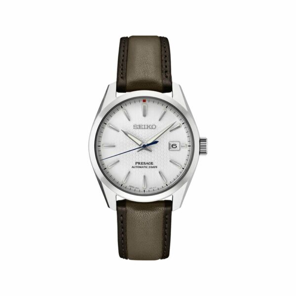 a white watch with brown leather straps