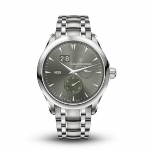 a silver watch with a green face