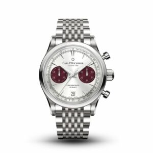 a silver watch with red numbers on the dial